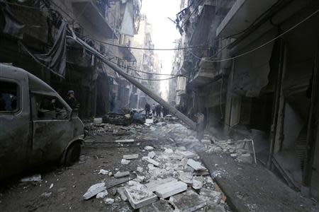 Residents look for survivors at a damaged site after what activists said was an air strike from forces loyal to Syria's President Bashar al-Assad in Takeek Al-Bab area of Aleppo