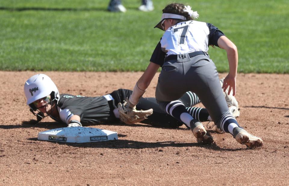 Allen Park's Makayla Sitarski slides safely into second base ahead of the tag by Macomb Dakota's Brooklyn Plitz during the Division 1 state final at Secchia Stadium on Michigan State campus on Saturday, June 18, 2022.