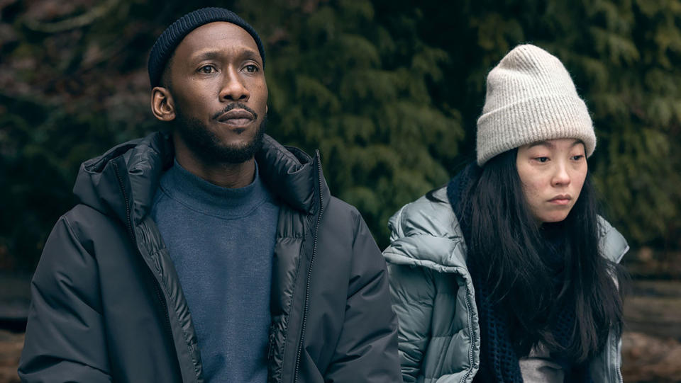 Mahershala Ali and Awkwafina wearing winter hats in Swan Song.