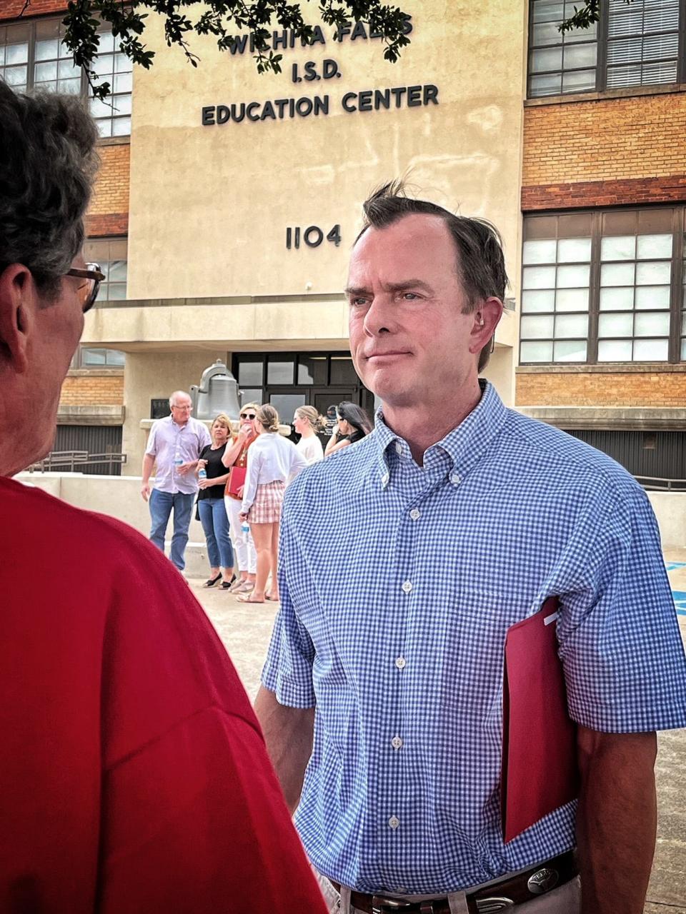 Mark Hood listens to a supporter Tuesday afternoon after announcing is candidacy for the Wichita Falls ISD school board. Hood is seeking the At-Large seat currently held by Elizabeth Yeager.