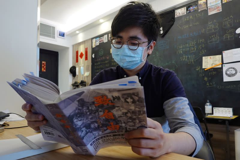 Publisher Raymond Yeung poses with a draft copy of "To Freedom" in Hong Kong