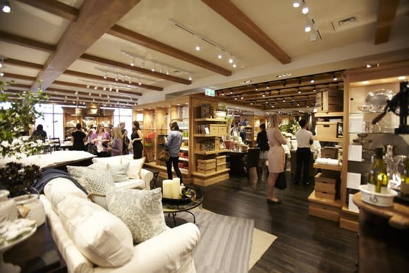 Interior of a Pottery Barn store with wood floors and ceiling beams