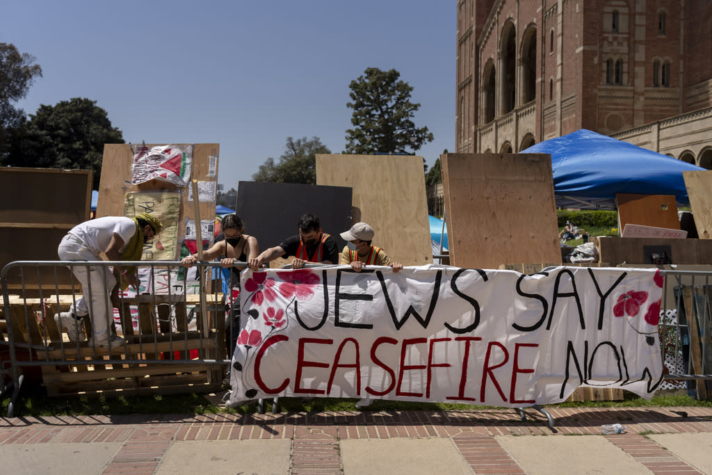 Pro-Palestinian protesters reinforce barricades around their encampment.