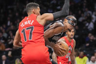 Brooklyn Nets center Nic Claxton drives against Toronto Raptors forward Garrett Temple (17) during the first half of an NBA basketball game Wednesday, April 10, 2024, in New York. (AP Photo/Mary Altaffer)