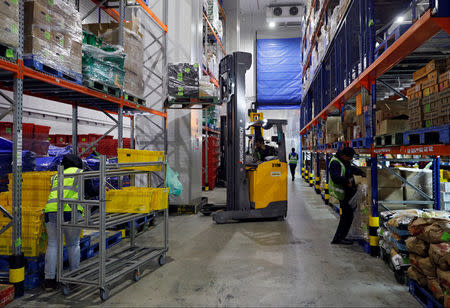 Employees work at RedMart's fulfillment centre in Singapore September 22, 2017. REUTERS/Edgar Su