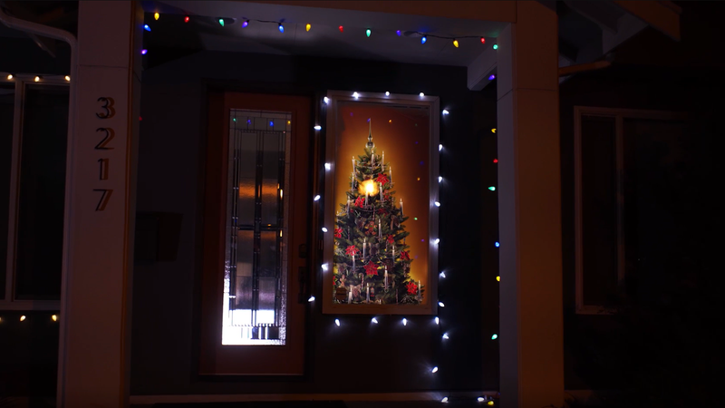A photo of a Christmas Tree being projected through the window