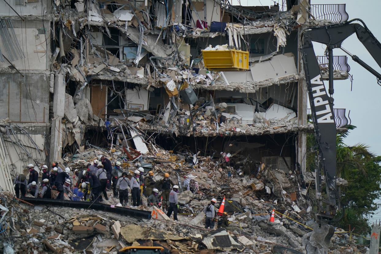 FILE - In this June 30, 2021, file photo, search and rescue personnel work atop the rubble at the Champlain Towers South condo building in Surfside, Fla.