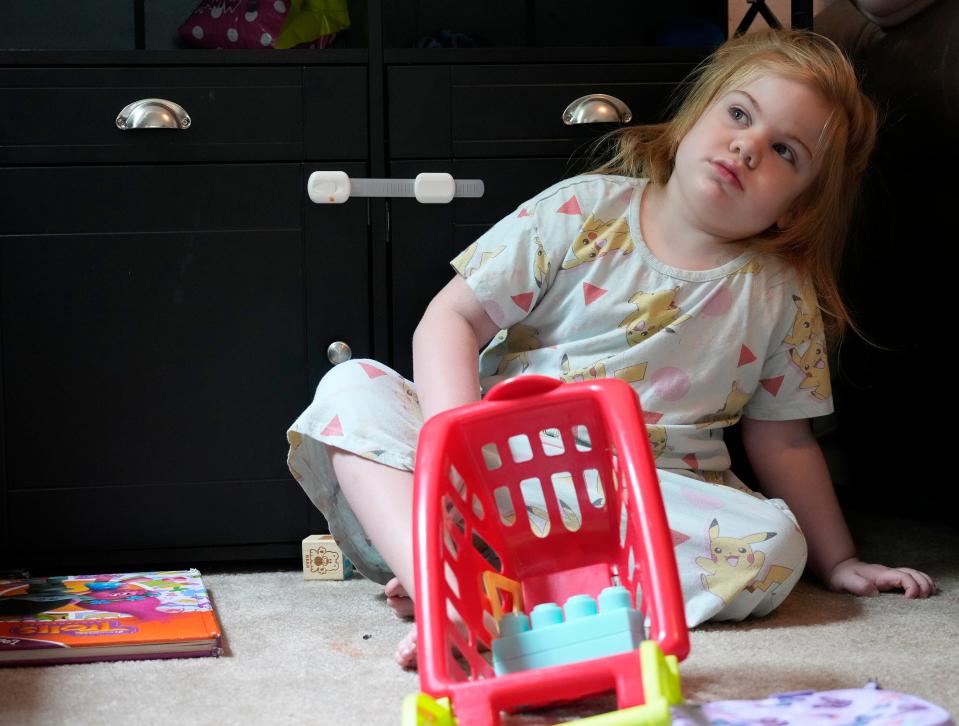 Veda Ulrich plays with her toys in the living room of the family's home in Palm Coast. Sanfilippo Syndrome, a rare disease, is robbing the little girl of her ability to speak and move. Typically, those with the disease die in their teen years.