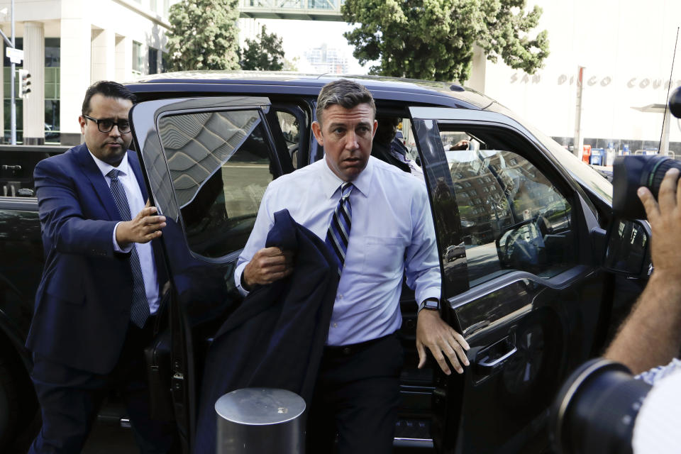 U.S. Rep. Duncan Hunter, center, arrives for an arraignment hearing Thursday, Aug. 23, 2018, in San Diego. Hunter and his wife were indicted Tuesday on federal charges that they used more than $250,000 in campaign funds for personal expenses that ranged from groceries to golf trips and lied about it in federal filings, prosecutors said. (AP Photo/Gregory Bull)
