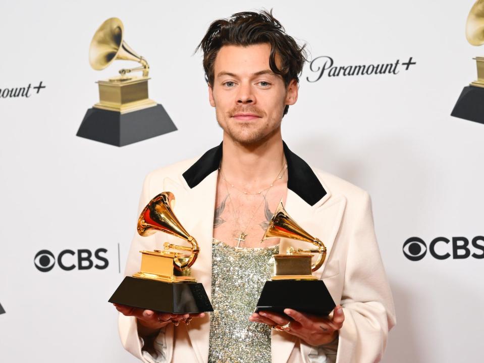 Harry Styles poses with his GRAMMY awards for Best Pop Vocal Album and Album of the Year for Harrys House in the Press Room at the 65th Annual GRAMMY Awards held at Crypto.com Arena on February 5, 2023