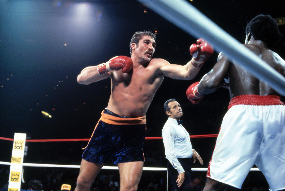 Gerrie Coetzee (left), who defeated Michael Dokes in 1983 for the WBA heavyweight title, died Thursday in South Africa at 67. (Photo by Getty Images)