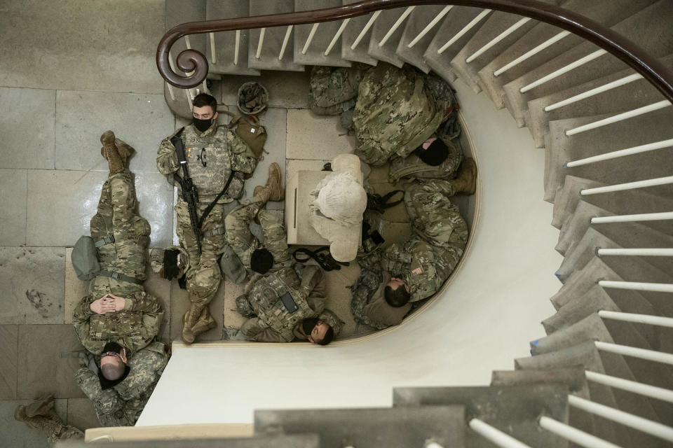 Members of the National Guard rest in a hallway of the Capitol building in Washington, on Jan. 13, 2021.<span class="copyright">Sarah Silbiger—Bloomberg/Getty Images</span>