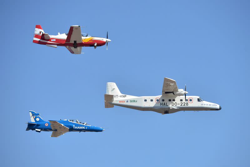 A Dornier, right, an HTT-40, top, and an Hawk Advanced Jet Trainer fly during a 2019 air show in Bangalore, India. (Manjunath Kiran/AFP via Getty Images)<cite class="op-small">MANJUNATH KIRAN</cite>