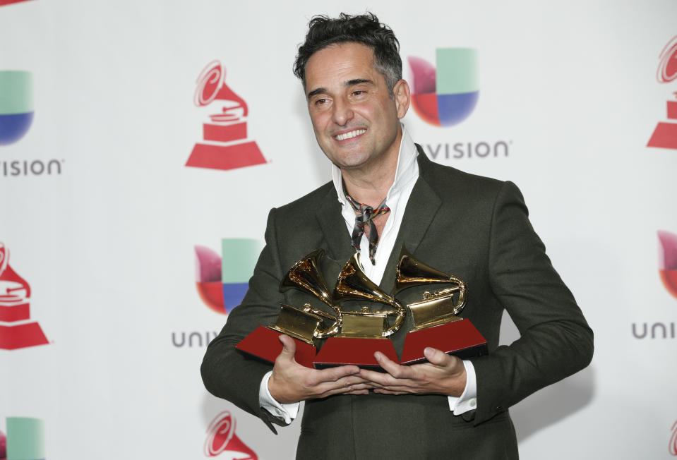 Jorge Drexler poses in the press room with the awards for best singer-songwriter album for "Salvavidas De Hielo," song of the year and record of the year for "Telefonia" at the Latin Grammy Awards on Thursday, Nov. 15, 2018, at the MGM Grand Garden Arena in Las Vegas. (Photo by Eric Jamison/Invision/AP)