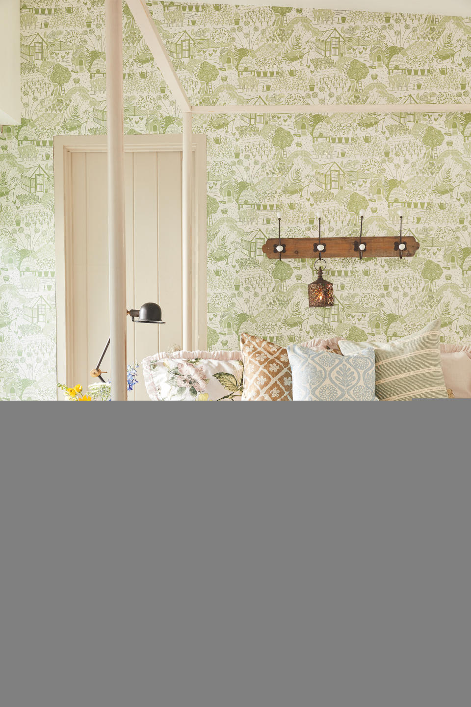 <p> If you're not a fan of florals, there are plenty of other ways to bring a decorate with wallpaper when you're looking for country bedroom ideas. </p> <p> The Allotment wallpaper by Sanderson evokes veggie patches and market gardens, and is a modern country take on traditional toile.  </p> <p> A row of hooks on a rustic board completes the quirky rural look. </p>