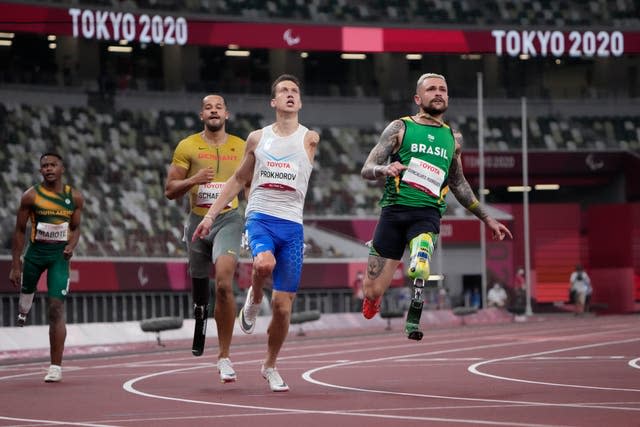 Vinicius Goncalves Rodrigues of Brazil (right) in flight before winning the men's 100m T63 final