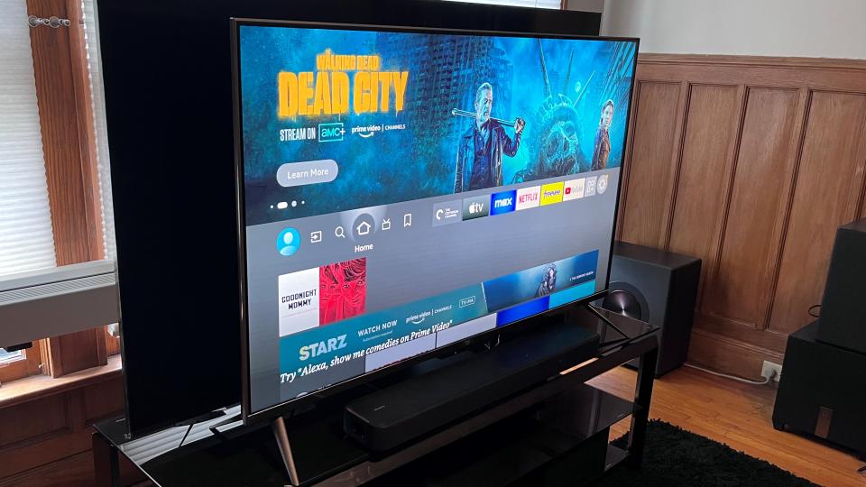 Amazon Fire TV Omni QLED shown from angle on TV stand