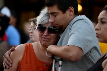 Justin Bates, a survivor of the Gilroy Garlic Festival mass shooting, and his mother, Lisa Barth, attend a vigil outside of Gilroy City Hall