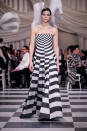 <p>A model wears a strapless mismatched black and white checkered and bull’s-eye patterned dress from the Dior Haute Couture SS18 collection. (Photo: Getty) </p>