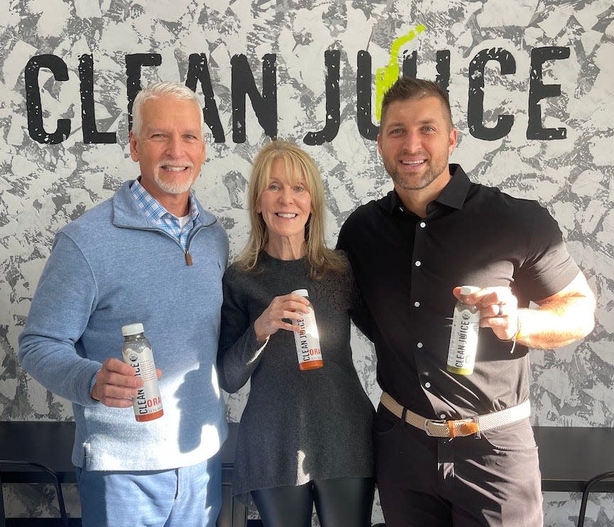 Former Florida Gators quarterback Tim Tebow, right, state Sen. Keith Perry and Deborah Butler, president of Butler Enterprises, at the ribbon-cutting ceremony for Tebow's latest Clean Juice restaurant, in Gainesville.