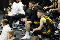 Injured Iowa guard Joe Wieskamp, center, watches from the bench during the second half of an NCAA college basketball game against Wisconsin, Sunday, March 7, 2021, in Iowa City, Iowa. (AP Photo/Charlie Neibergall)