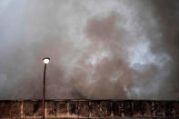 <p>Smoke rises from a fire in a building at Tokyo’s Tsukiji fish market on August 3, 2017. (Photo: Behrouz Mehri/AFP/Getty Images) </p>