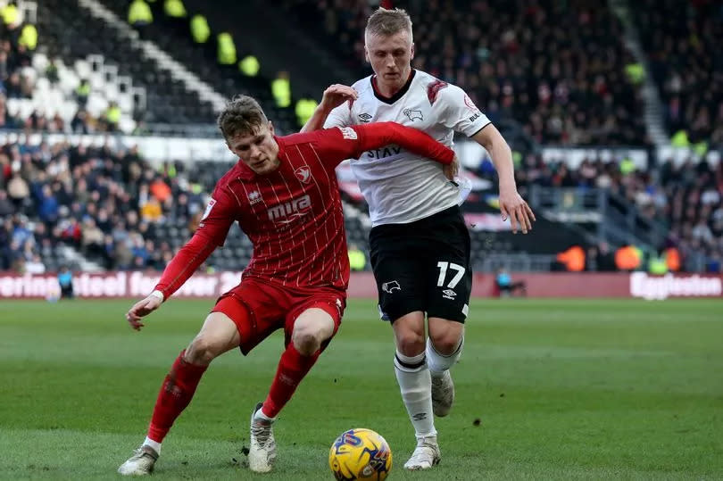 Cheltenham Town's Rob Street (left) and Derby County's Louie Sibley battle for the ball