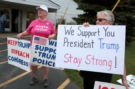 Pro-gun President Trump supporters hold signs outside a "End The Gun Violence" Town Hall in Michigan