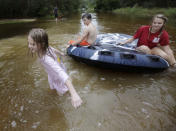 <p>Crimson Peters, 7, left, Tracy Neilsen, 13, center, and Macee Nelson, 15, ride in an inner tube down a flooded street after Hurricane Nate, Sunday, Oct. 8, 2017, in Coden, Ala. (Photo: Brynn Anderson/AP) </p>