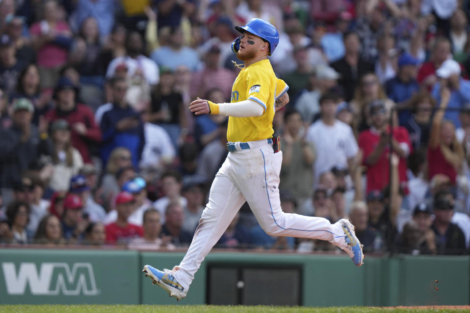 Boston Red Sox's Alex Verdugo arrives at home plate to score on a single by Justin Turner in the sixth inning of the first game of a baseball doubleheader against the New York Yankees, Sunday, June 18, 2023, in Boston. (AP Photo/Steven Senne)