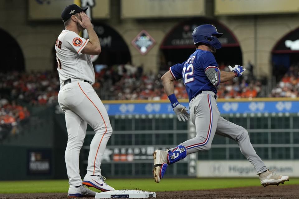 Texas Rangers' Evan Carter rounds first after a hit during the second inning of Game 1 of the baseball AL Championship Series against the Houston Astros Sunday, Oct. 15, 2023, in Houston. (AP Photo/Godofredo A. Vasquez)