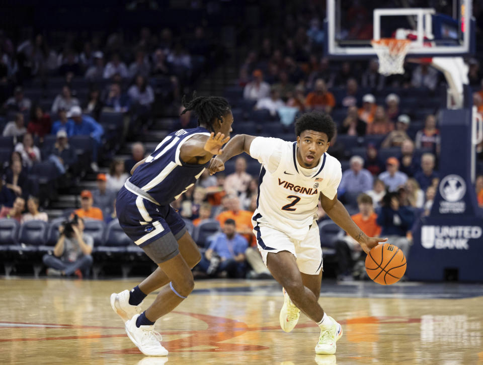 Virginia's Reece Beekman (2) drives with the ball against Monmouth during the first half of an NCAA college basketball game in Charlottesville, Va., Friday, Nov. 11, 2022. (AP Photo/Mike Kropf)