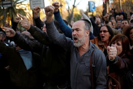 Garbage collectors from waste management company Limasa, who have been on strike since March 1 against wage cuts, and are demanding better working conditions, protest outside the town hall during a strike in Malaga, southern Spain, March 10, 2016. REUTERS/Jon Nazca/File Photo