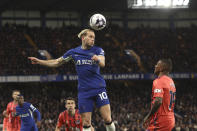 Chelsea's Mykhailo Mudryk heads the ball ahead of Everton's Ashley Young during the English Premier League soccer match between Chelsea and Everton at Stamford Bridge stadium in London, Monday, April 15, 2024. (AP Photo/Ian Walton)