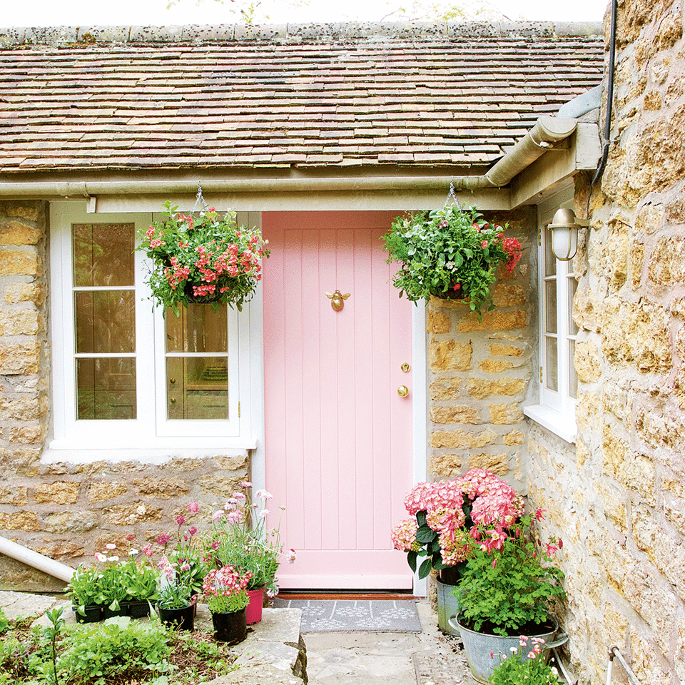 Hanging basket next to pink front door