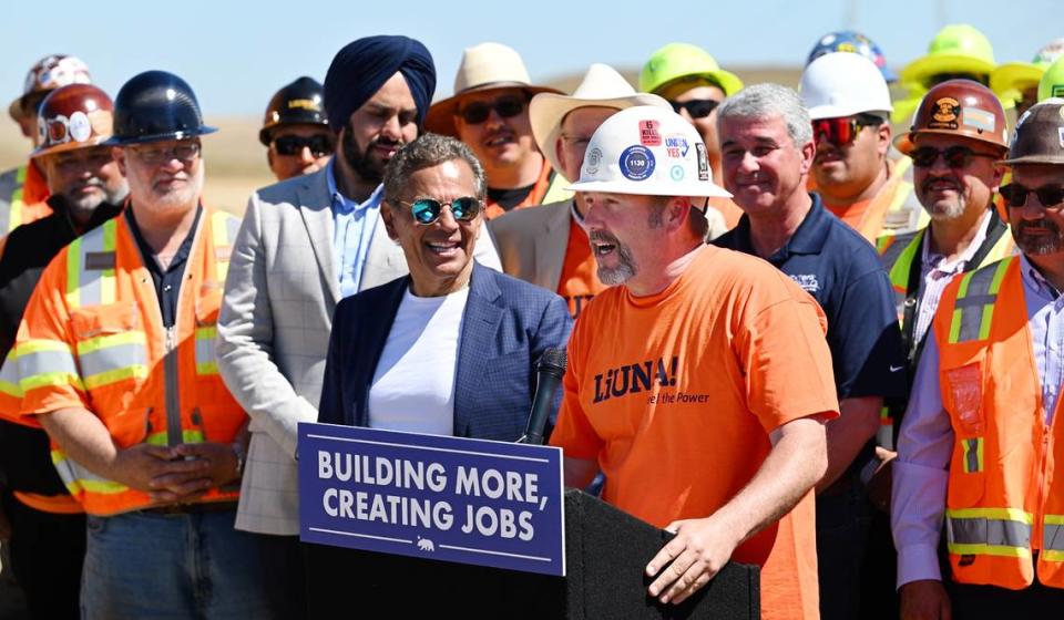 California infrastructure advisor Antonio Villaraigosa, middle left, and others listen to Joshua Lepper from the Laborers Local 1330, during a visit by Gov. Gavin Newsom at the Proxima Solar Farm under construction outside Patterson, Calif., Friday, May 19, 2023.