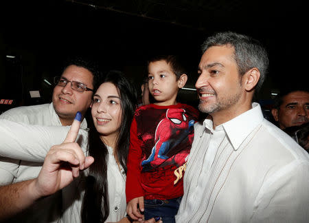 Paraguayan presidential candidate Mario Abdo Benitez of the Colorado Partido poses for a picture with supporters after casting his vote during the election in Asuncion, Paraguay, April 22, 2018. REUTERS/Andres Stapff