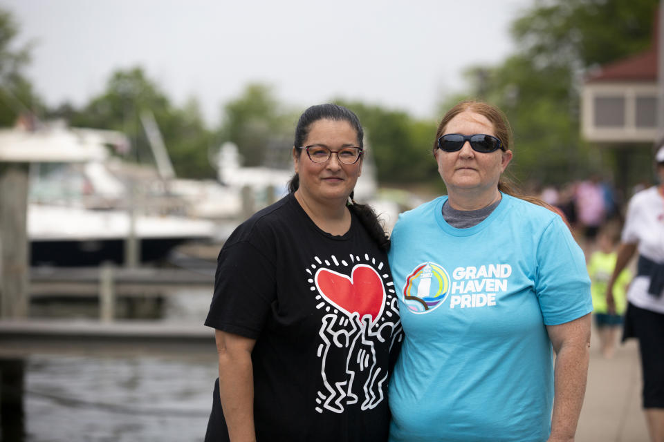 Shawn Duncan poses for a portrait with her wife, Betty during Grand Haven Pride Fest in Grand Haven, Mich., on Saturday, June 10, 2023. On Saturday, surrounded by allies and members of the LGBTQ community who had descended on Grand Haven's downtown for the city's inaugural Pride Festival, the Duncans held hands for the first time publicly in the town. It was time to celebrate, Shawn said, after decades in the closet. (AP Photo/Kristen Norman)