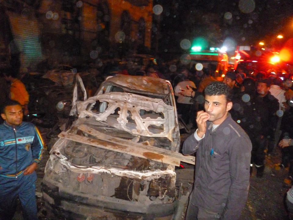 FILE - In this file photo taken early on Tuesday, Dec. 24. 2013, Egyptians gather after an explosion believed to be caused by a car bomb rocked a police headquarters in the Nile Delta city of Mansoura, 110 kilometers (70 miles) north of Cairo, Egypt. The militant group Ansar Beit al-Maqdis, which has waged a campaign of bombings and assassinations for months in Egypt, has quickly advanced in weaponry and sophistication of attacks, drawing on the experience of Egyptians who fought in Syria. (AP Photo, File)