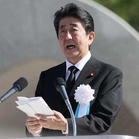 Japan's Prime Minister Shinzo Abe delivers a speech during 72nd anniversary memorial service for the atomic bomb victims at the Peace Memorial Park in Hiroshima - Credit: AFP PHOTO / JIJI PRESS / STR