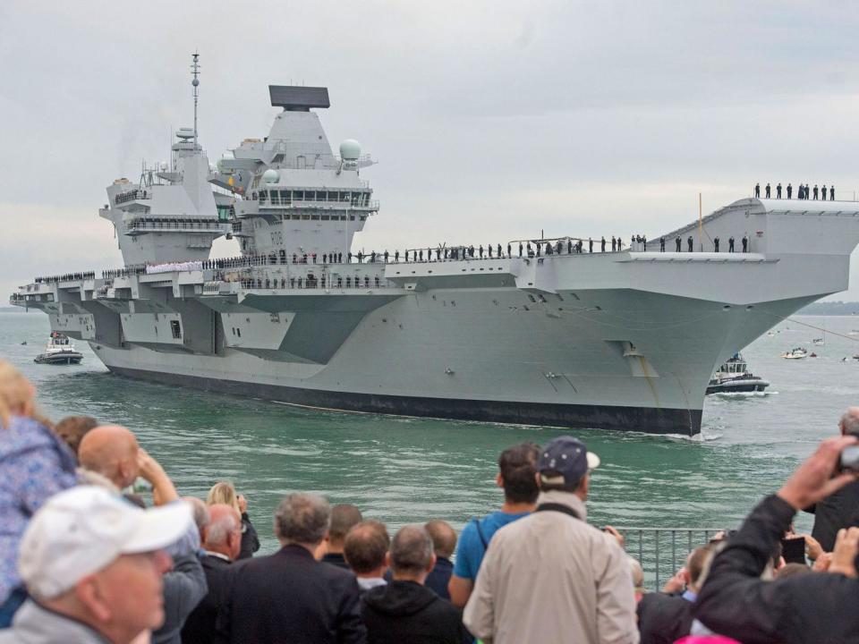 Crowds watch as HMS Queen Elizabeth, the UK's newest aircraft carrier, arrives in Portsmouth. (PA)