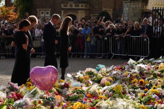 The royal couples look at the piles of floral tributes lining the road in Windsor. (Photo: Kirsty O'Connor via PA Wire/PA Images)