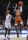 Apr 2, 2019; New York, NY, USA; Texas Longhorns guard Kerwin Roach II (12) shoots over Texas Christian Horned Frogs guard RJ Nembhard (22) in the second half of the NIT semifinals at Madison Square Garden. Mandatory Credit: Wendell Cruz-USA TODAY Sports