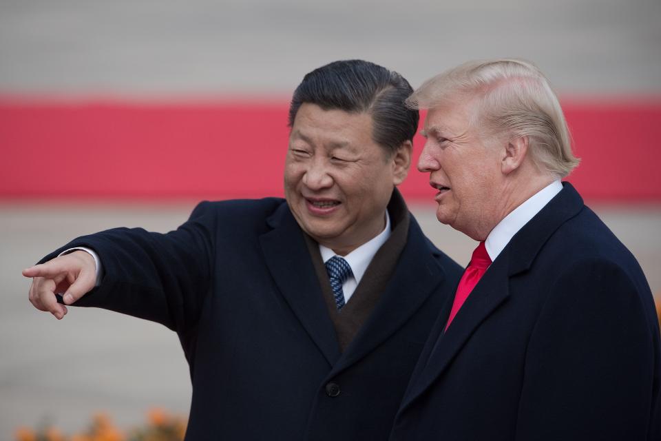 (FILES) In this file photo taken on November 9, 2017 China's President Xi Jinping (L) and US President Donald Trump attend a welcome ceremony at the Great Hall of the People in Beijing. - President Donald Trump on September 18, 2018 accused China of seeking to influence upcoming US elections by taking aim at his political support base in the countries' escalating trade war. "China has openly stated that they are actively trying to impact and change our election by attacking our farmers, ranchers and industrial workers because of their loyalty to me," Trump tweeted.Trump's comments came a day after he targeted another $200 billion in Chinese imports with tariffs starting next week, drawing an immediate vow of retaliation from Beijing. (Photo by NICOLAS ASFOURI / AFP)NICOLAS ASFOURI/AFP/Getty Images ORIG FILE ID: AFP_1977Q6