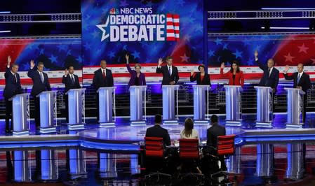 Candidates raise hands at the first U.S. 2020 presidential election Democratic candidates debate in Miami, Florida, U.S.,
