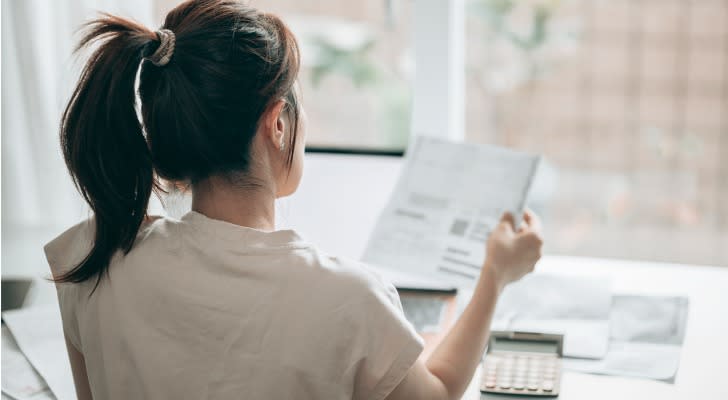 A woman researching the differences between MAGI vs. AGI before filing her taxes.