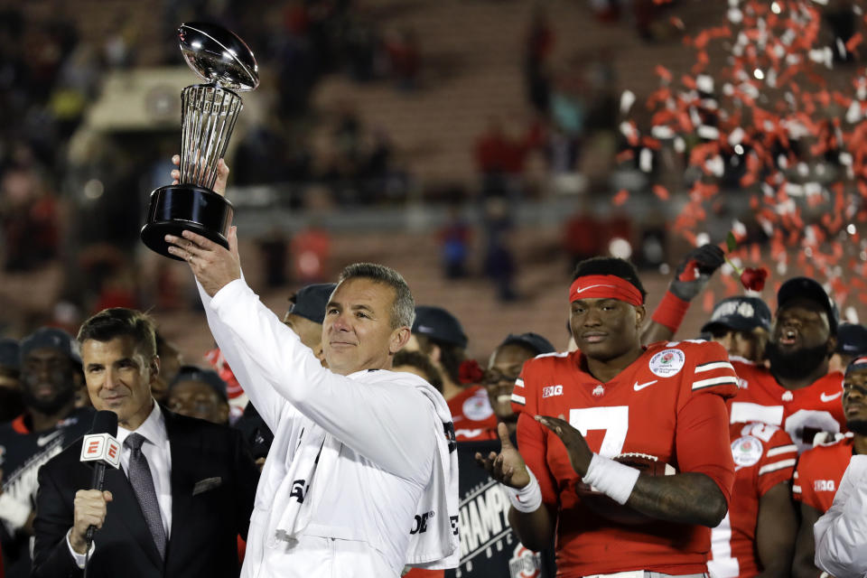 Ohio State coach Urban Meyer holds up the trophy after Ohio State defeated Washington 28-23 during the Rose Bowl NCAA college football game Tuesday, Jan. 1, 2019, in Pasadena, Calif. (AP Photo/Marcio Jose Sanchez)