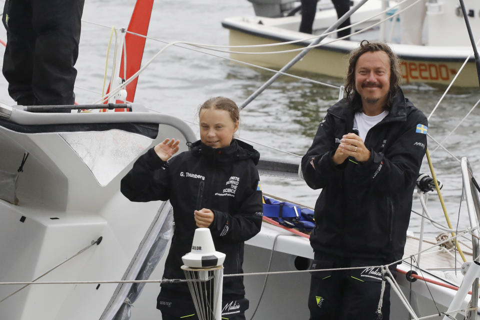 Greta Thunberg, a 16-year-old Swedish environmental activist, stands with her father Sventa Thunberg after arriving in New York harbor aboard the Malizia II, Wednesday, Aug. 28, 2019. The zero-emissions yacht left Plymouth, England on August 14. Thunberg is scheduled to address the United Nations Climate Action Summit on Sept. 23. (AP Photo/Mark Lennihan)