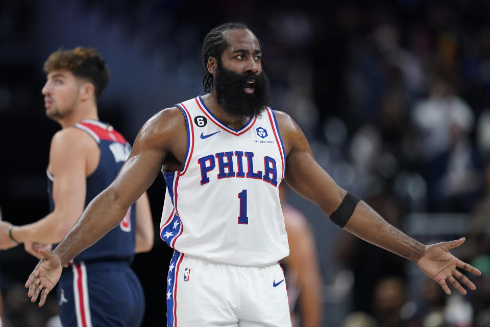 Philadelphia 76ers guard James Harden reacts after being fouled by Washington Wizards forward Deni Avdija, back left, of Israel, while shooting in the first half of an NBA basketball game, Monday, Oct. 31, 2022, in Washington. (AP Photo/Patrick Semansky)