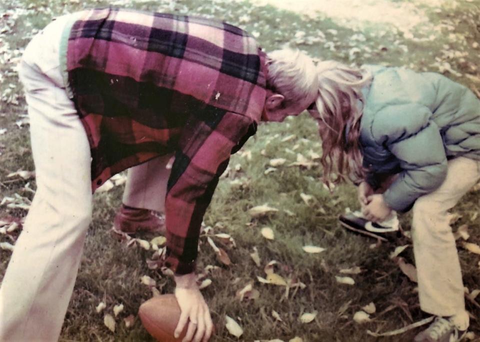 Randy Wright gives some football tips to his athletic daughter, Amy, at their home in Norwell circa 1980. Amy went on to become a field hockey standout in high school and at Cornell University, where she was elected to its Athletic Hall of Fame.